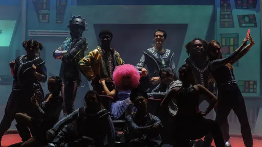 10 actors clustered on the deck of a spaceship