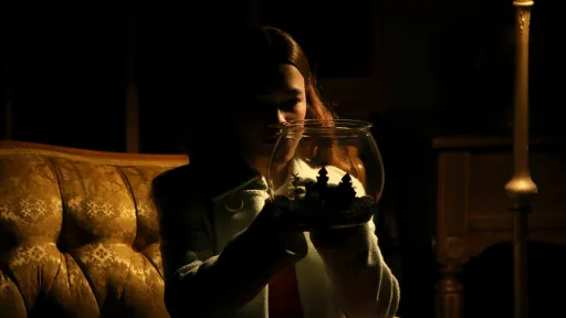 Girl holding a goldfish bowl