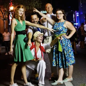 5 actors clumped together pointing in different directions.  